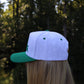 "He's Golfing" Embroidered Two Tone Hat - Green
